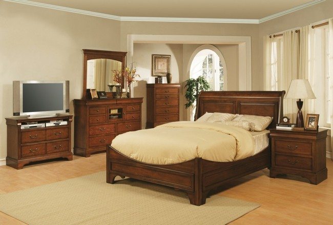 dark wooden double bed with chest draw and table with wooden mirror