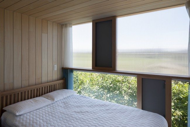 wooden ceiling and walls with double bed