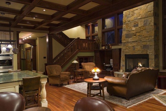 vintage living room with stone fireplace and wooden floor