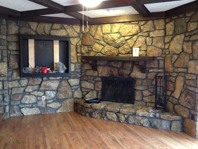 rustic interior stone rock fireplace , castle style living room