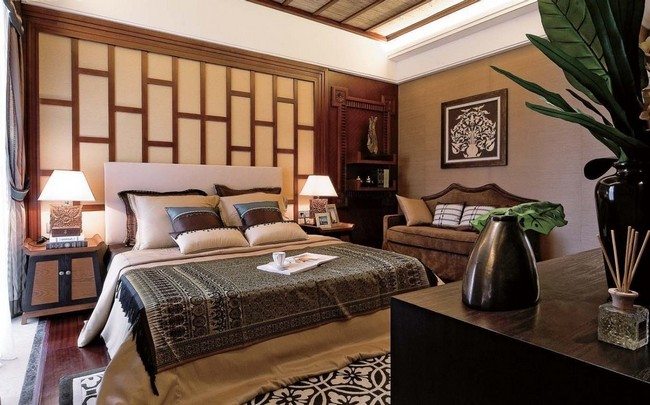 feng shui asian inspired decorating with king size classic bed and chesterfield sofa with stone vase