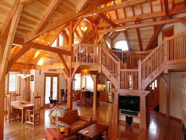 wooden living room with ledders anf wooden attic