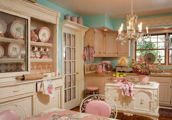 rose style kitchen with green walls,plenty of small puppets on the cup board