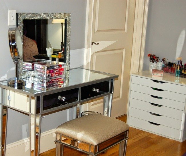 mirrored makeup table with two drawres and mirror on the wall