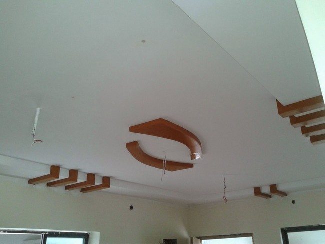 white ceiling with wooden chahdlier