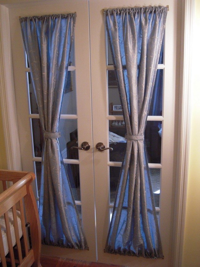 Plastic french doors with blyu curtains tied up together
