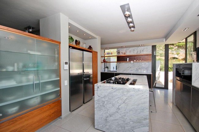 Large rectangular kitchen with distinct cooking and storage areas