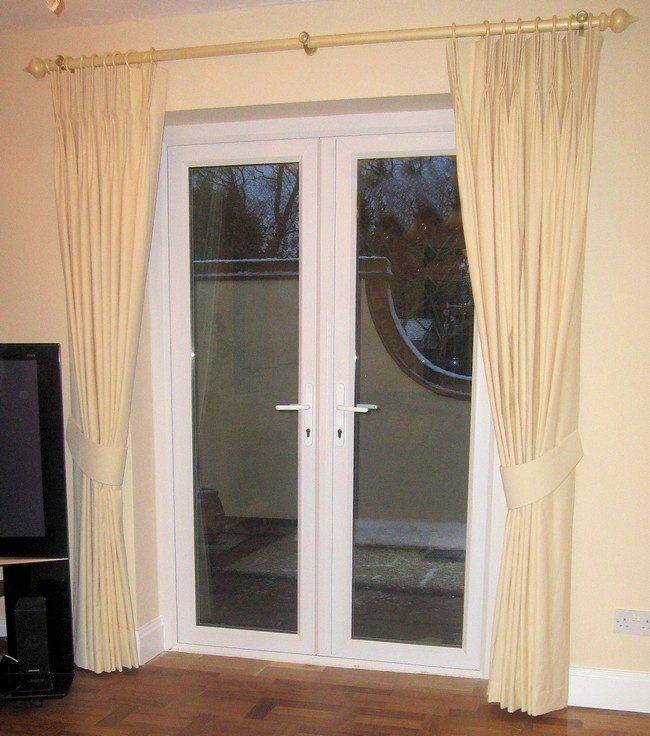 plastic french doors with white curtains