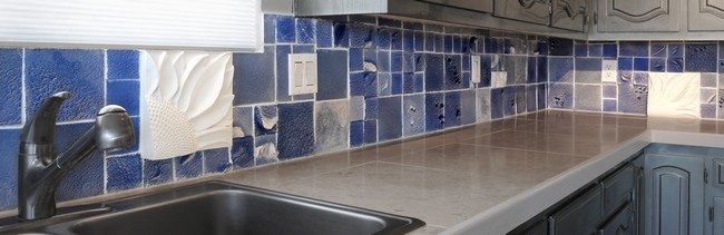 blue color brick splashes in the marble kitchen