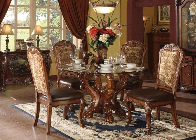round glass table with awsome legs and four chairs with soft leather seats 
