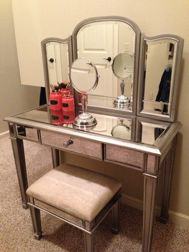 mirrored makeup storage table with one drawer and small soft square chair