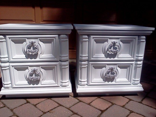 two white classic night stands with the handle as a lion head