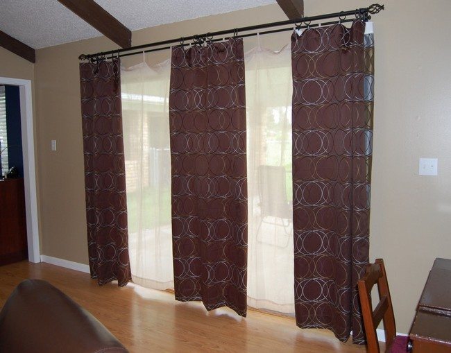 two frecnh doors with three brown curtains