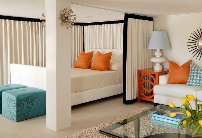 white curtain as a room divider for a double bed