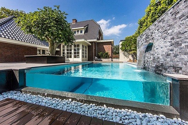 pool with glass wall in the backyard