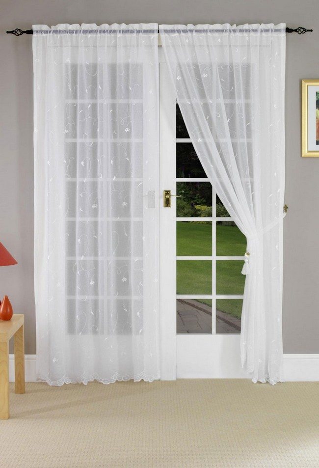 white wooden french doors with light lucid curtains