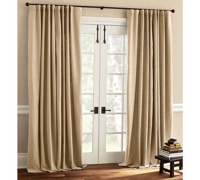 wooden white doors with brown metal handles with solid creme curtains