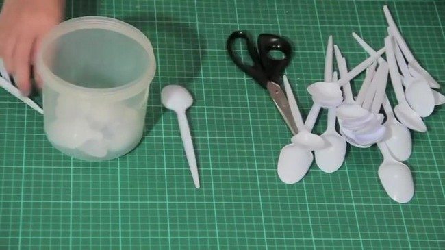A bunch of white plastic spoons on table
