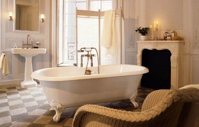 White clawfoot tub with long, gold faucet