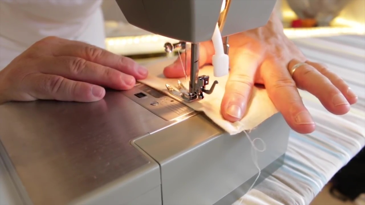 Process of hemming the overlapping edges using sewing machine 