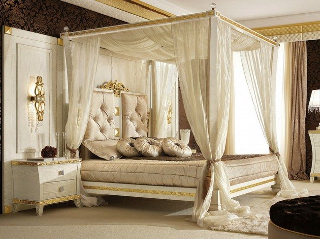 Sheer white curtains surrounding four-poster bed