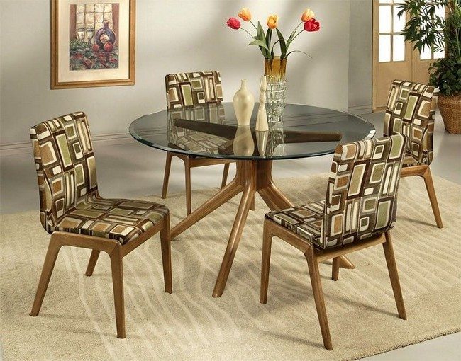 Simple wooden dining chairs upholstered in traditional African fabric