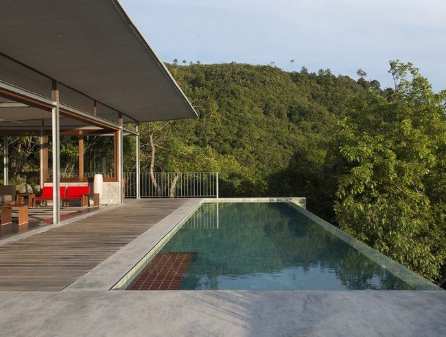 Swimming pool on a patio overlooking a forest