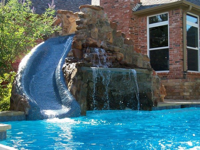 Swimming pool built adjacent to brick house