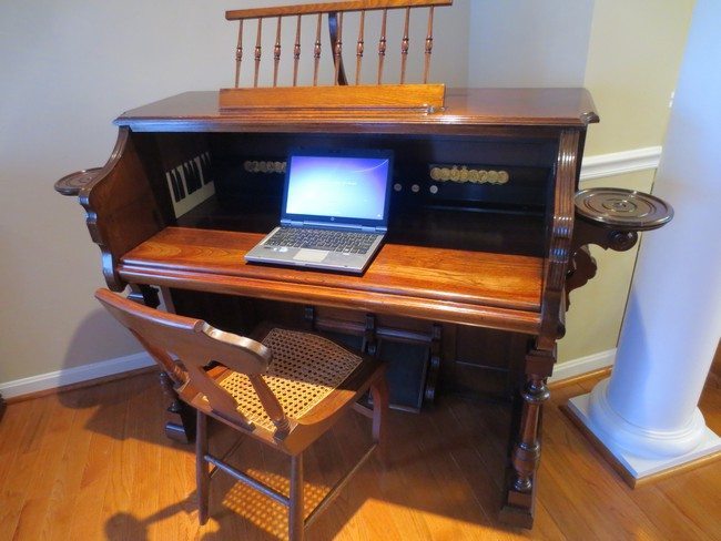 Repurposed wooden piano used as study/ workstation
