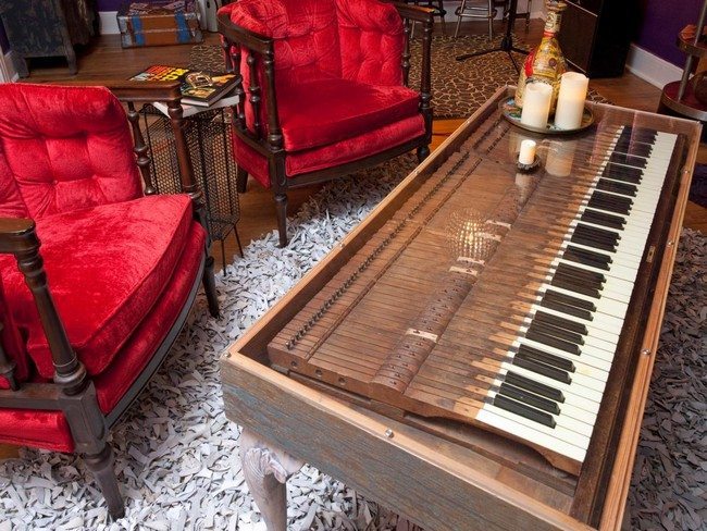 Long, wooden piano used as coffee table