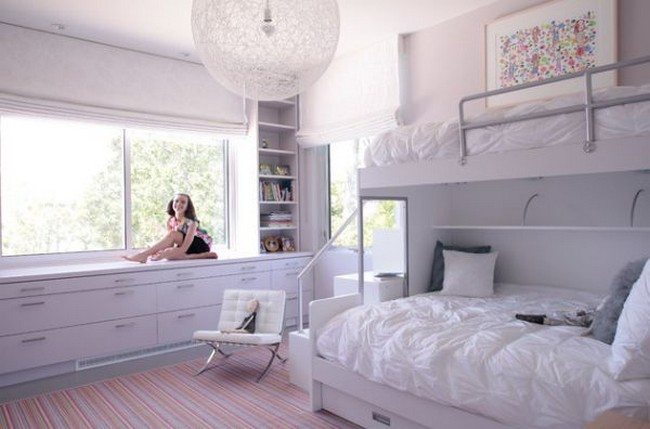 Contemporary girls’ bedroom in white with plush bunk beds and contemporary lighting feature 