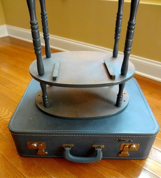 Blue suitcase on hardwood floor