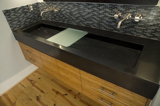 Large rectangular sink on top of wooden cabinet with drawers