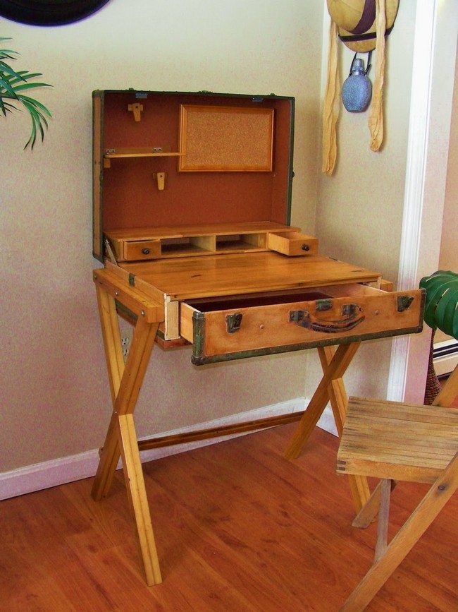 Old wooden suitcase repurposed into a desk, with a drawer for storage