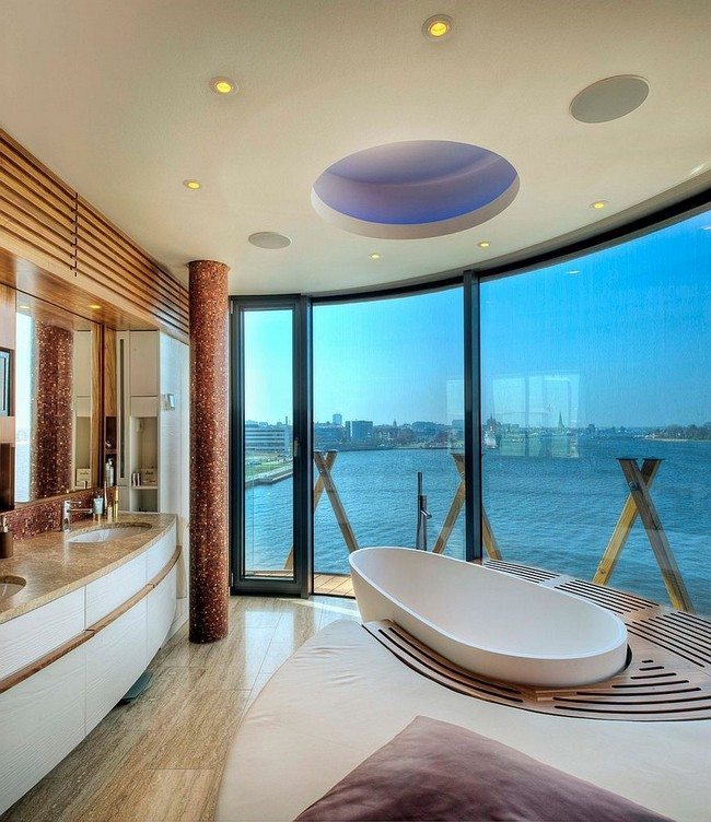 Bathroom with large glass doors surrounded by wooden deck