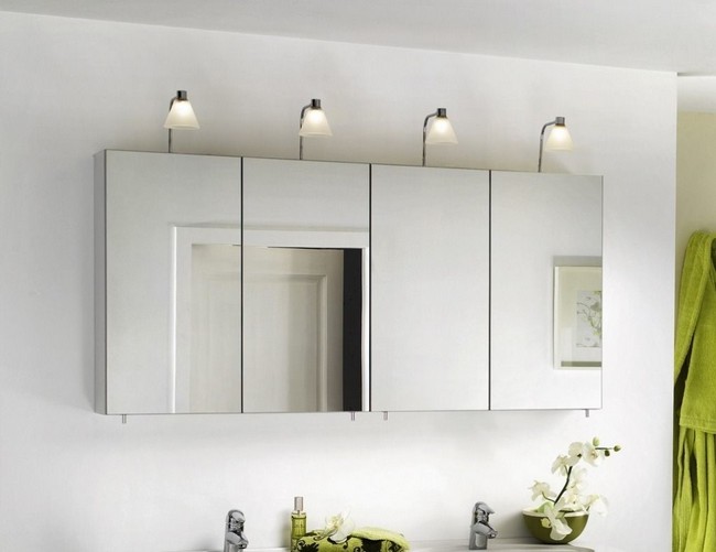 Series of contemporary bathroom cabinet mirrors beneath white lights