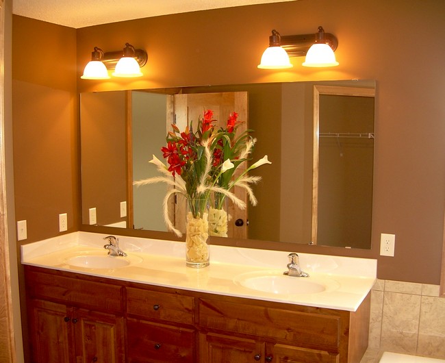 Bright sconce lights above a large mirror
