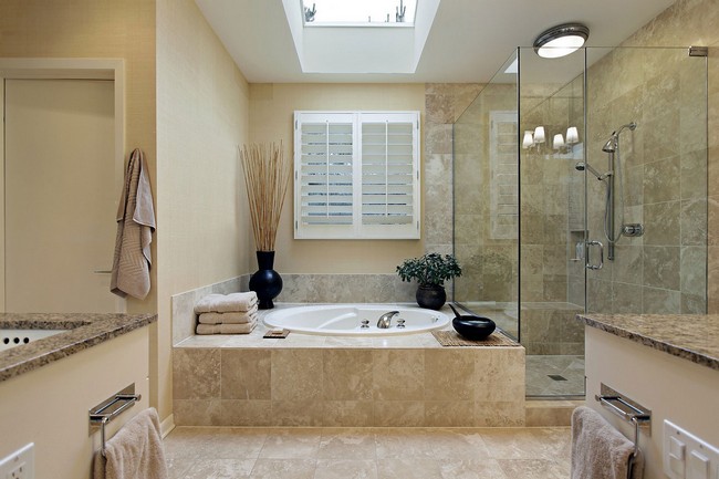 Clear-cut marble bathroom design with skylight overhead the bathtub