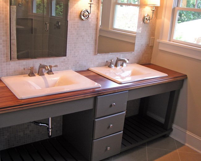 Brown wooden countertop with two white, marble sinks