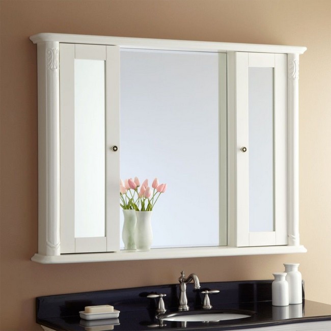 Modern mirror placed between double doors of wall cabinet