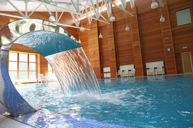 Large indoor pool with waterfall