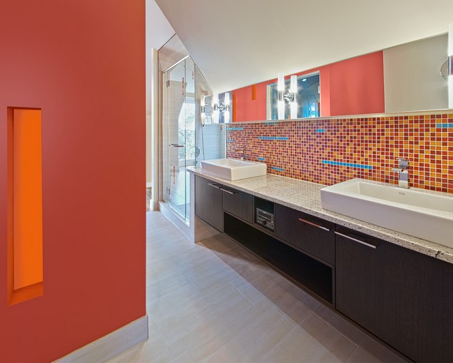  Large rectangular mirror covering upper section of wall, with lower section covered in tile with diverse color palette