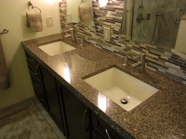 Brown countertop matching brown and white mosaic tile backsplash