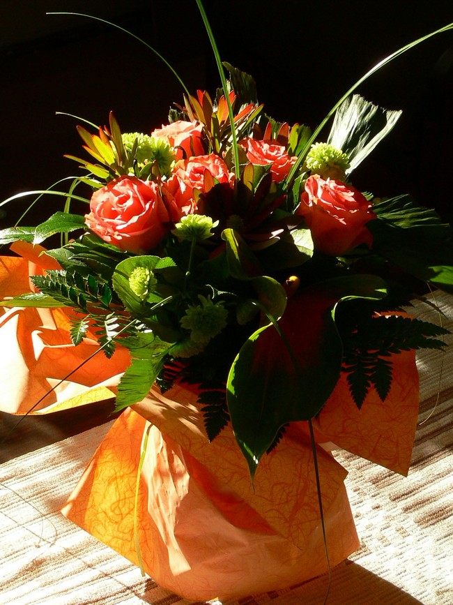 Orange fabric wrapped around ordinary vase to create elegant DIY vase