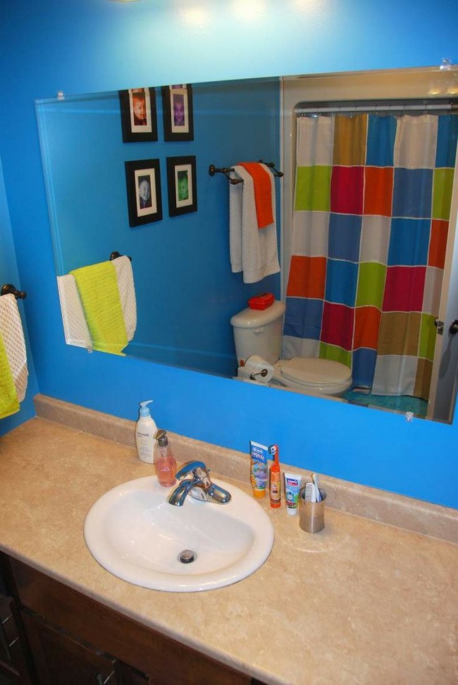 Bathroom with bright blue wall and colorful shower curtain