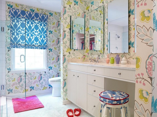 Bathroom with mirrors and colorful prints in wallpaper and shower curtain