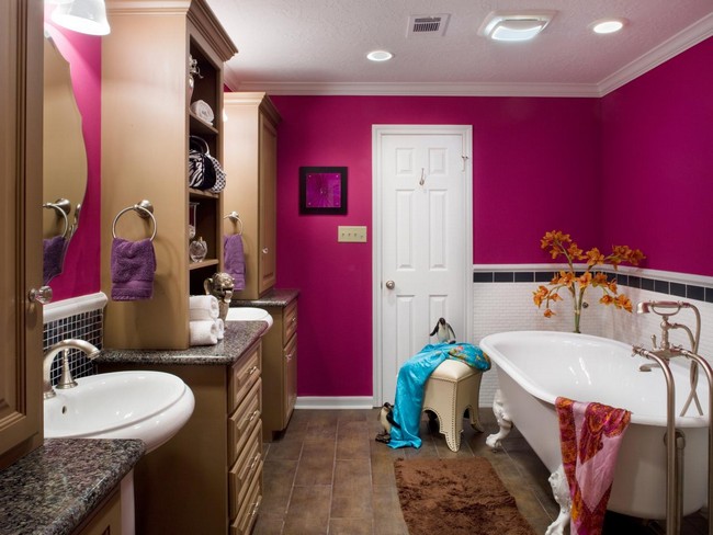 Girl’s bathroom with bright pink walls and in-ceiling lighting