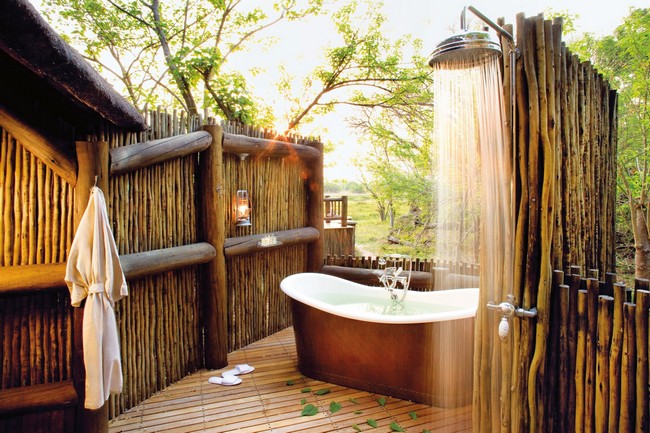 Outdoor bathtub and rain shower enclosed in a bamboo structure