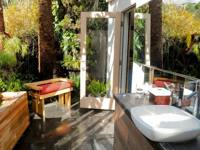 Bright outdoor shower area with stand-alone sink and modern vanity set