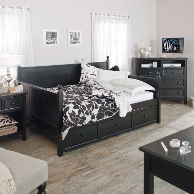 Pale hardwood flooring adds simple neutral elegance to this black and white bedroom